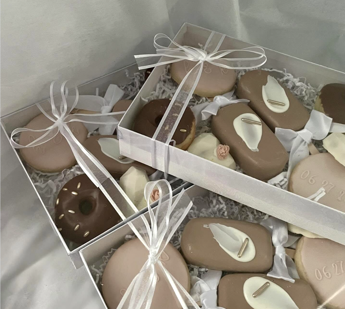 Beige and cream donut and cookie gift box with white satin ribbons