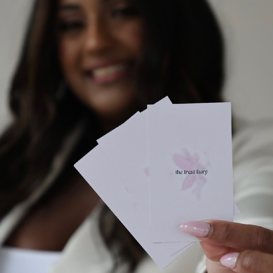 Alissa holding fanned The Treat Fairy branded business cards