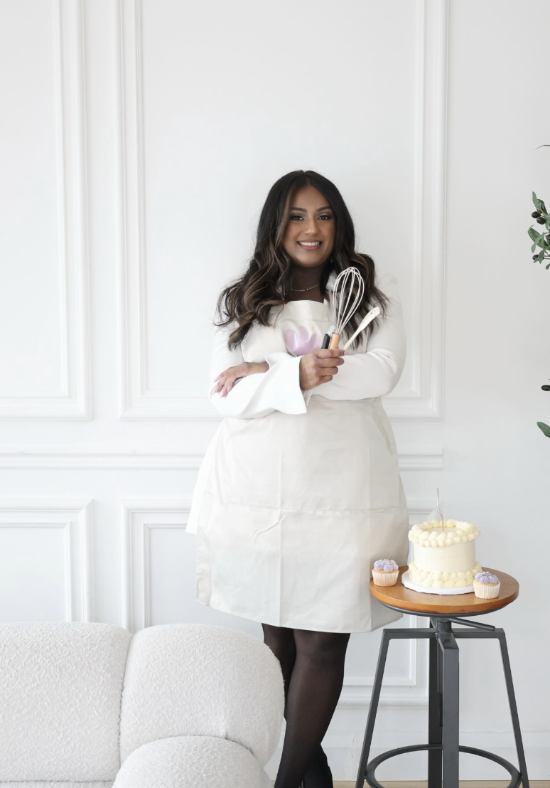 Alissa in Treat Fairy apron holding whisks
