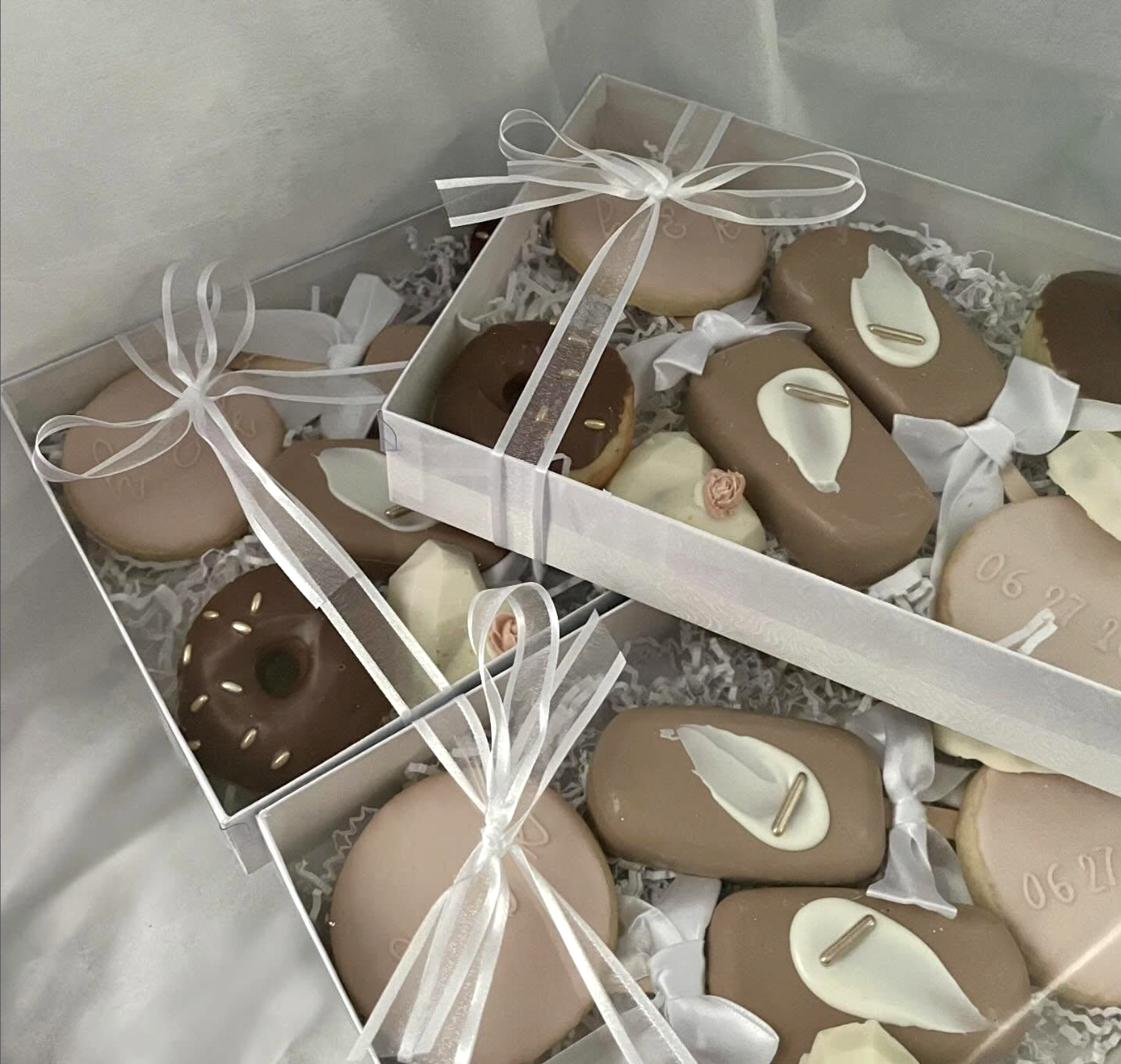 Custom chocolate dessert box with white chocolate accents, ribbon, and piped dates