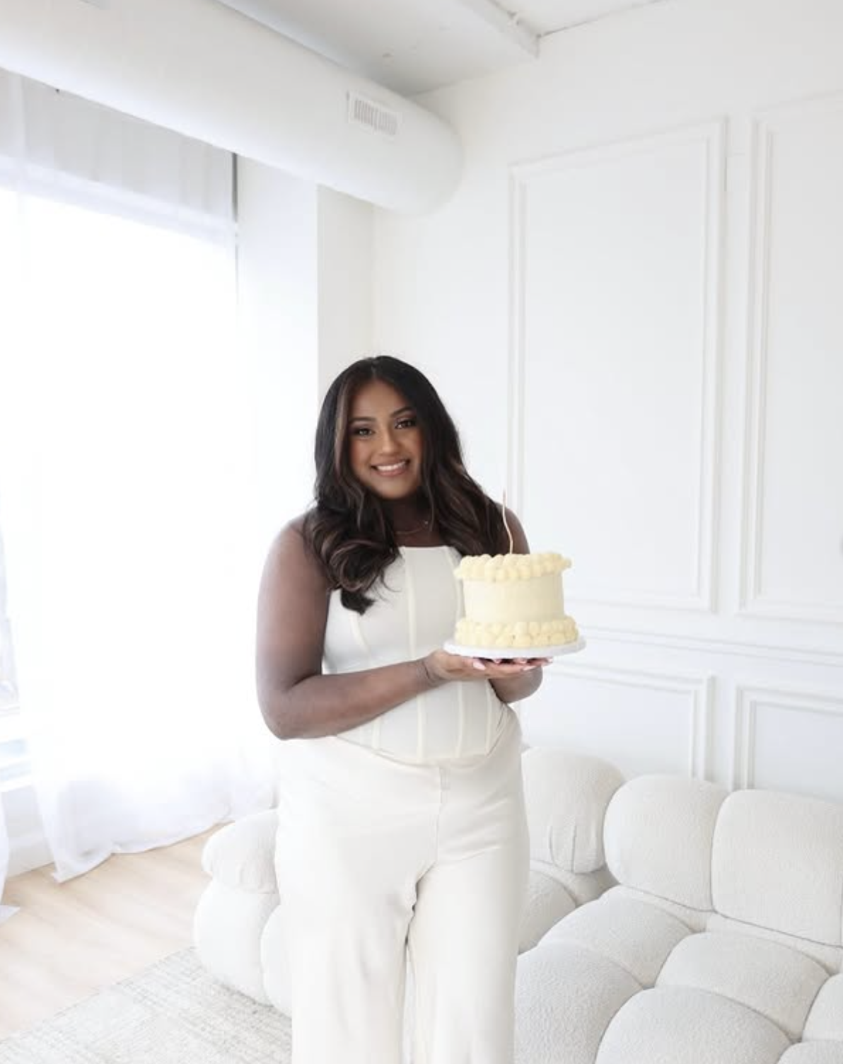 Alissa holding a smash cake in her studio